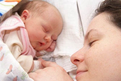 mother sleeping with baby