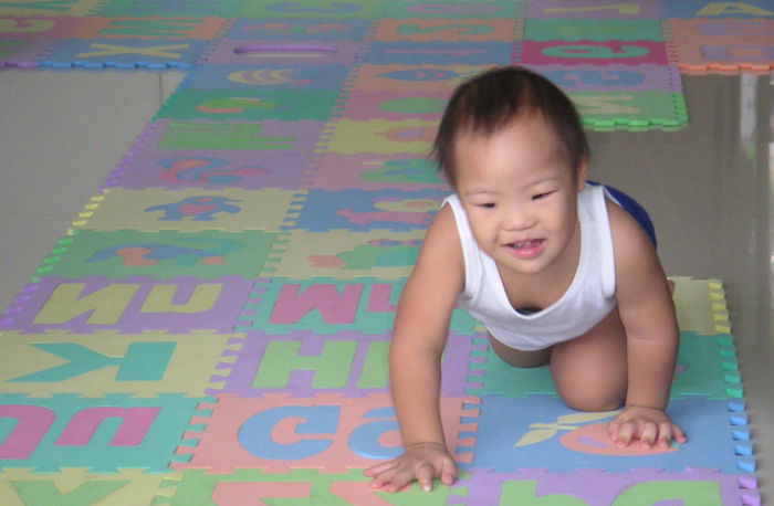 baby with special needs crawling on the floor