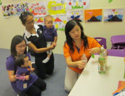 Teacher Jasmine (in orange) from LEAP Schoolhouse