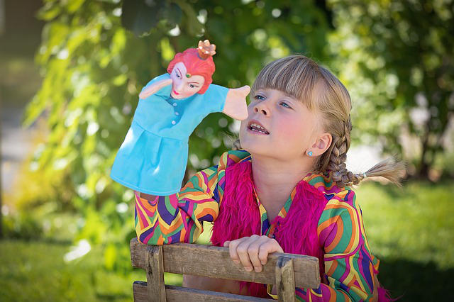 child playing with puppet