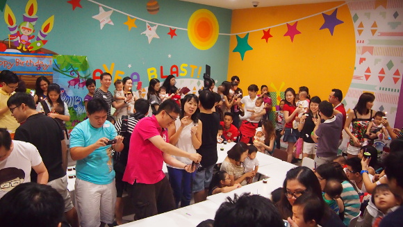 Parents gathered for a group birthday bash organised for their little ones