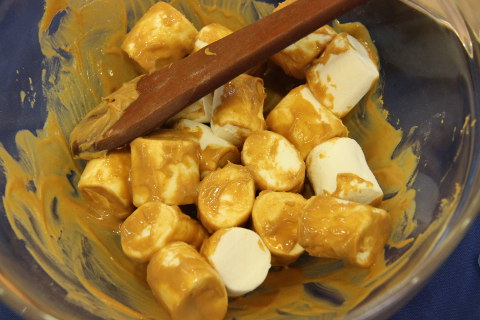 cover marshmallows in peanut butter