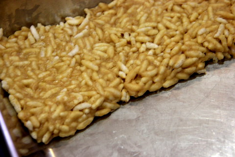 spread rice cereal out evenly on the tray