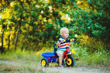 toddler riding on a tricycle