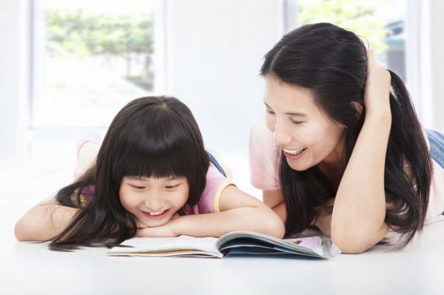 Daughter and mummy reading a book