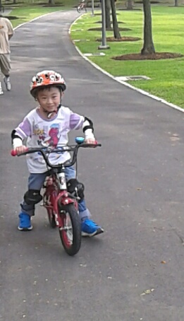 Boy learning how to ride a bicycle