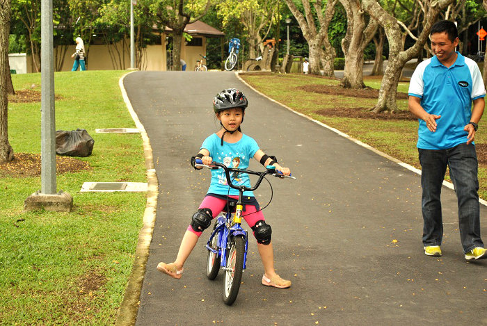 Child learning how to ride on a learner bicycle