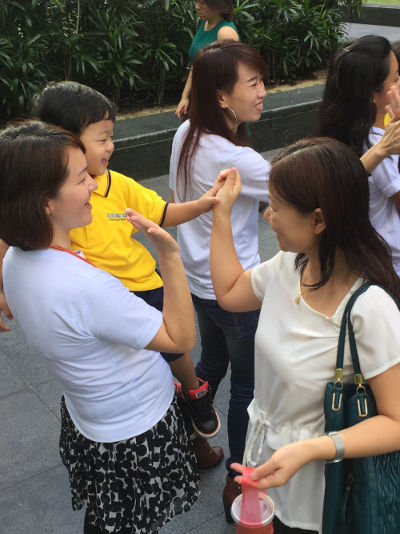 Dreamkids children high fiving public at Raffles City