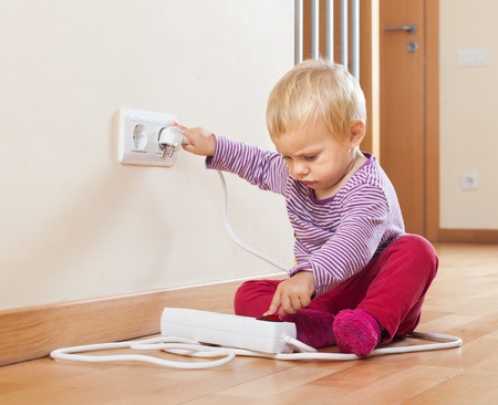 Baby playing with electrical extension