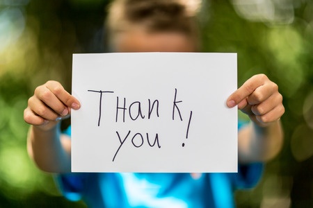 Boy holding thank you words