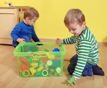 children picking up toys