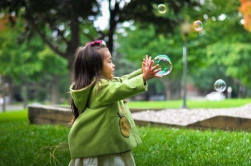 Toddler playing with bubbles