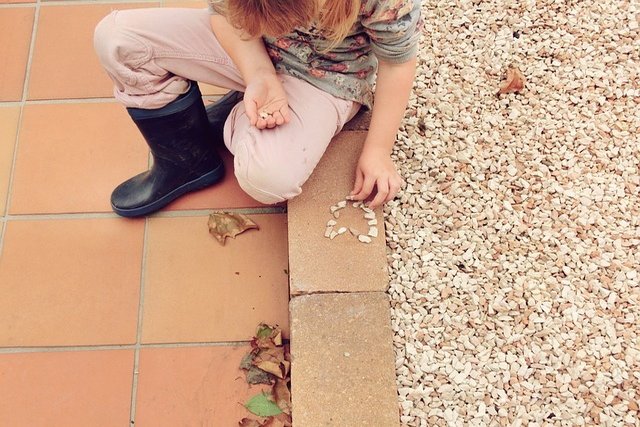 Girl collecting pebbles