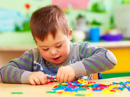 Child with down syndrome playing