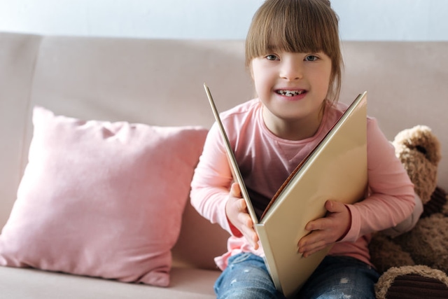 Kid with down syndrome reading