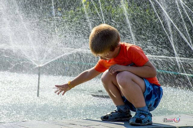 energetic boy child playing with water