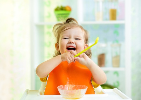 toddler having baby food